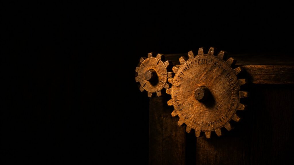 Two interlocked wooden gears, one small and one large, representing the weekly and annual Sabbaths turning together
